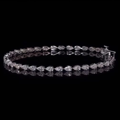 Glamorous Glow: The Luxurious Solitaire Pear Diamond Tennis...